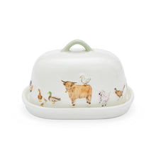 A white ceramic butter dish with a matching lid, decorated with a whimsical illustration of farm animals including a Highland cow, duck, goose, chicken, and pig. The lid features a light sage green handle.