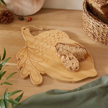 Cartco Cooksmart Forest Fable bamboo cutting board shaped like an acorn with engraved woodland design and bread slices