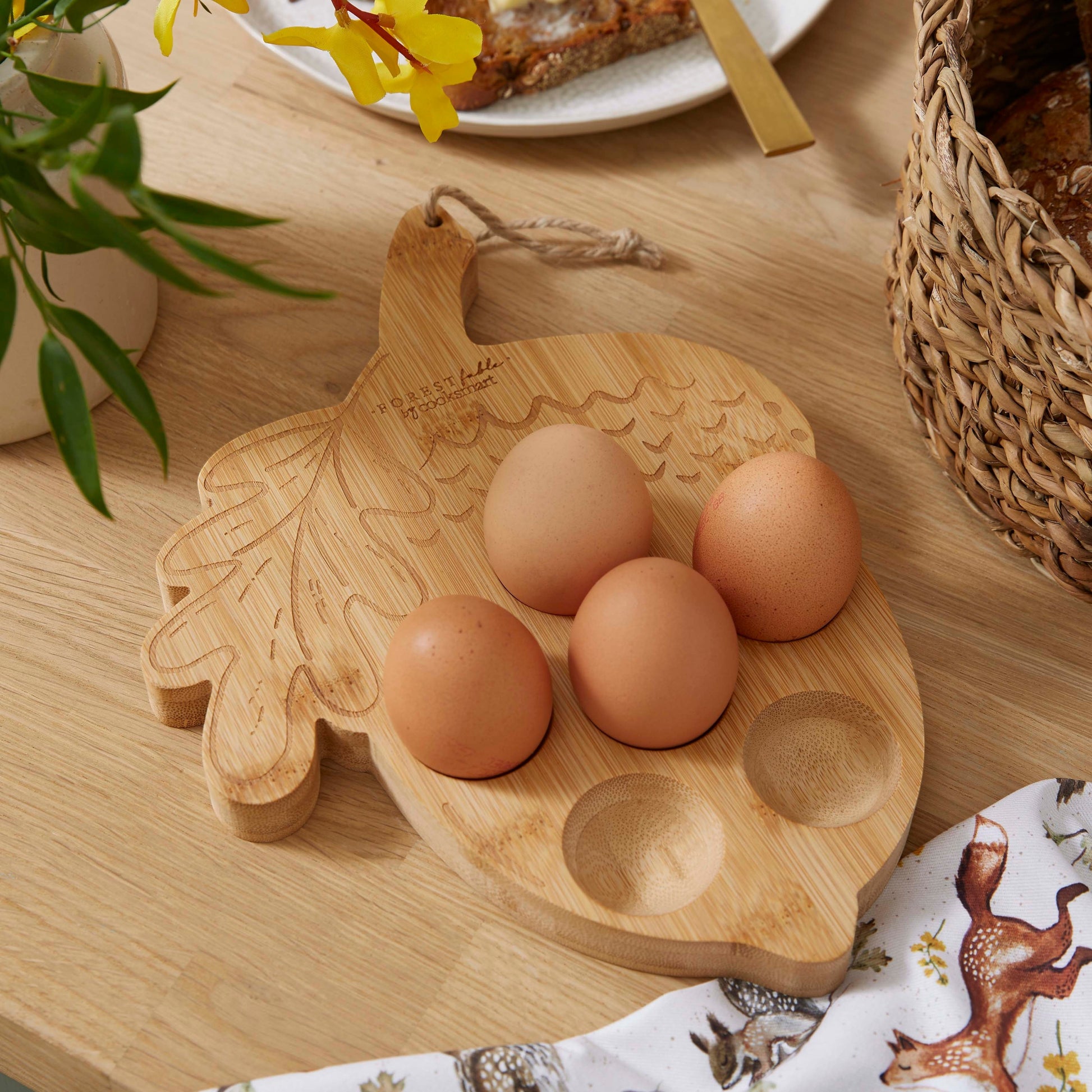 Cartco Cooksmart Forest Fable bamboo egg holder shaped like an oak leaf with woodland animal engravings