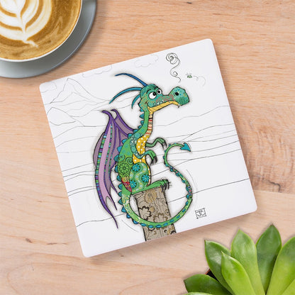 Cartco square ceramic coaster featuring a whimsical green and purple Duncan Dragon illustration on a wooden table.