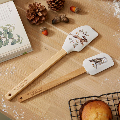 Cartco Cooksmart Forest Fable set of two bamboo spatulas featuring woodland hare and owl illustrations on a wooden table