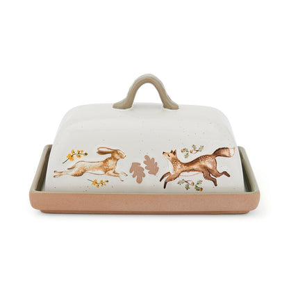 Cartco Cooksmart Forest Fable ceramic butter dish with hare and fox illustration, sage green handle, and cream cover.