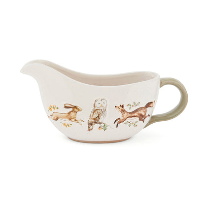Cartco Cooksmart Forest Fable ceramic gravy boat with woodland hare, owl, and fox illustrations and sage green handle.
