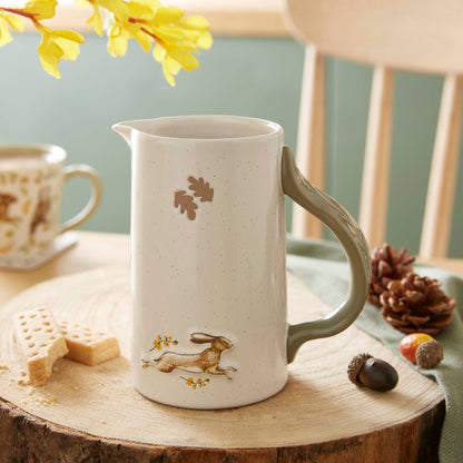 Cartco Cooksmart Forest Fable ceramic jug with a running hare, golden botanical accents, and a sage green handle.