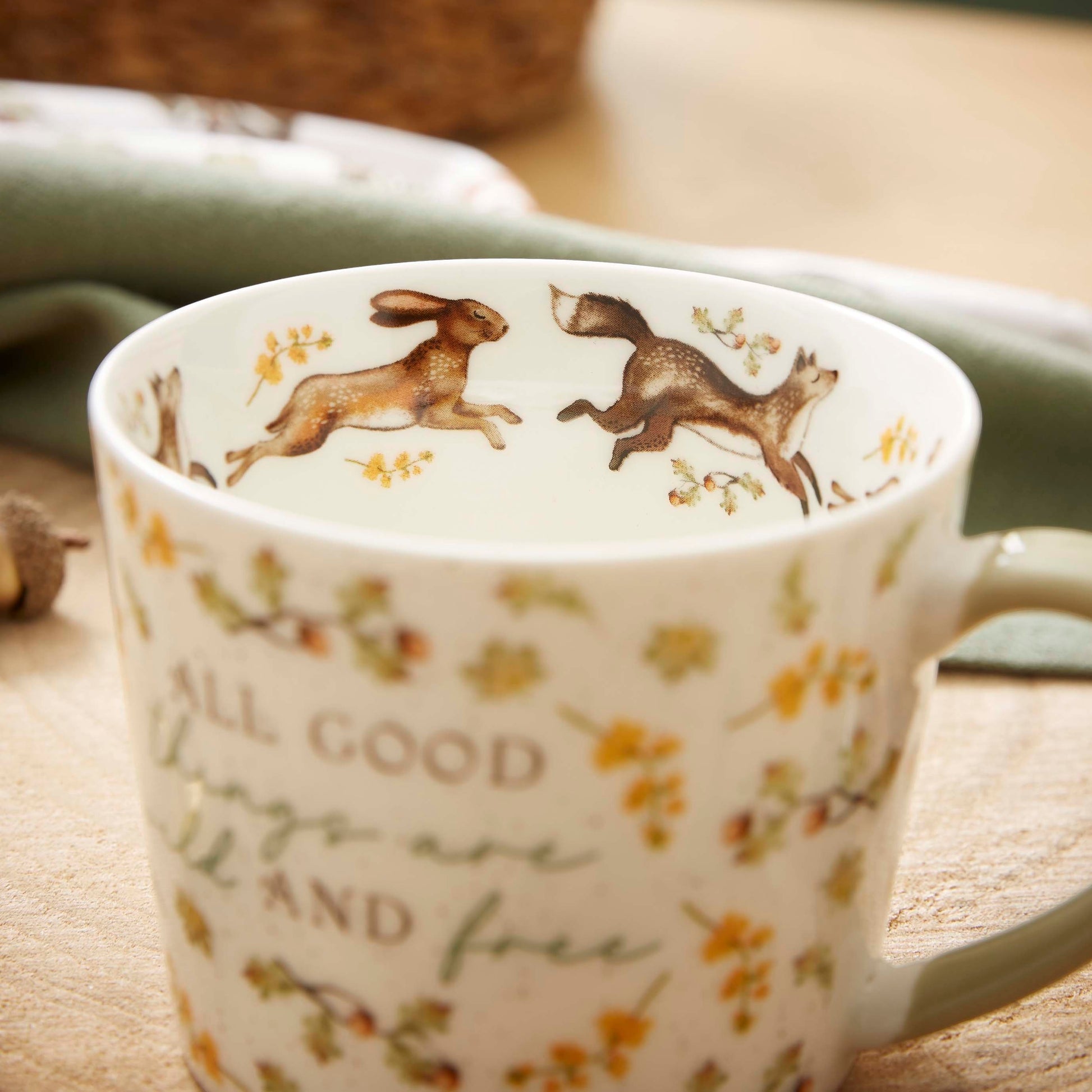 Cartco Cooksmart Forest Fable ceramic mug with woodland animals, botanical leaves, and sage green handle.