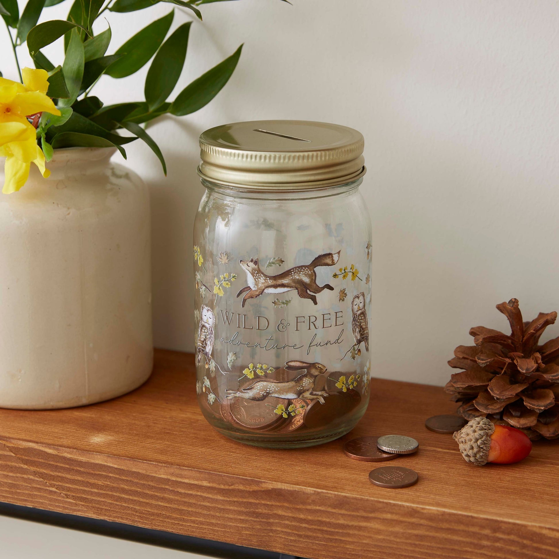 Cartco Cooksmart Forest Fable glass money jar with woodland animal illustrations and a gold metal lid