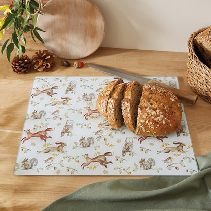 Cartco Cooksmart Forest Fable glass worktop saver with woodland animal illustrations on a wooden kitchen counter