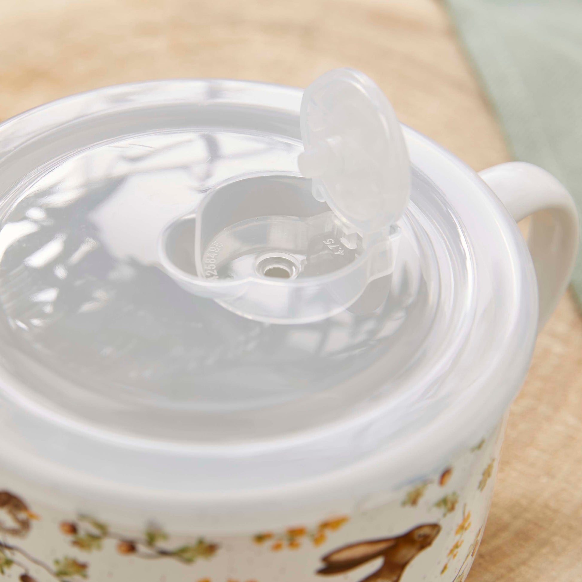 Cartco Cooksmart Forest Fable ceramic soup mug with a clear plastic lid featuring a steam vent