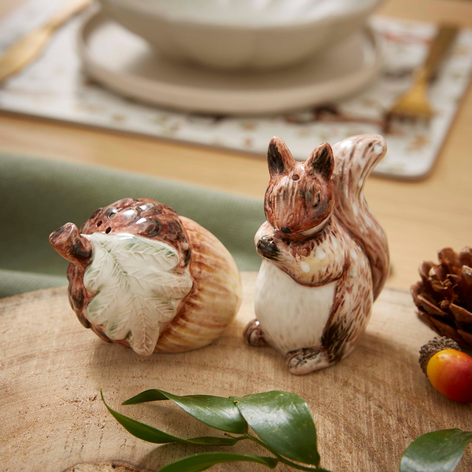 Cartco Cooksmart Forest Fable ceramic salt and pepper shaker set featuring a sculpted squirrel and acorn design.