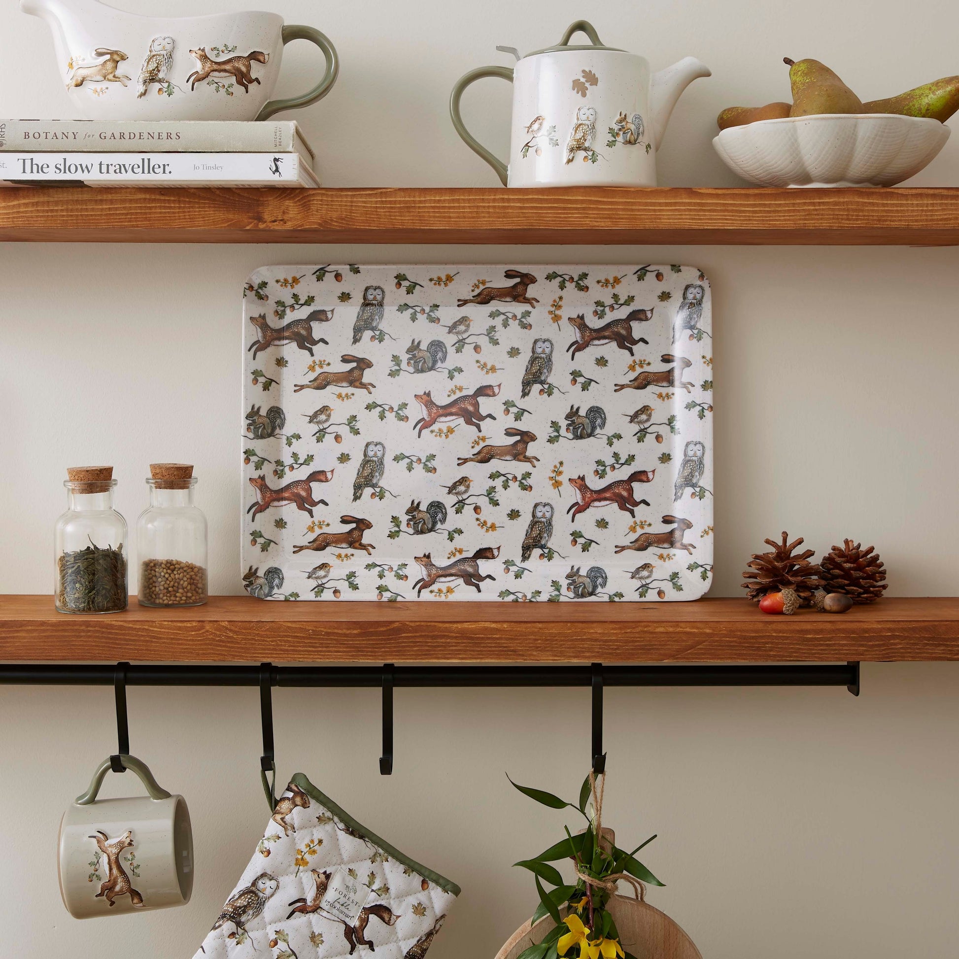 Cartco Cooksmart Forest Fable large rectangular serving tray featuring a woodland animal print on a kitchen shelf.