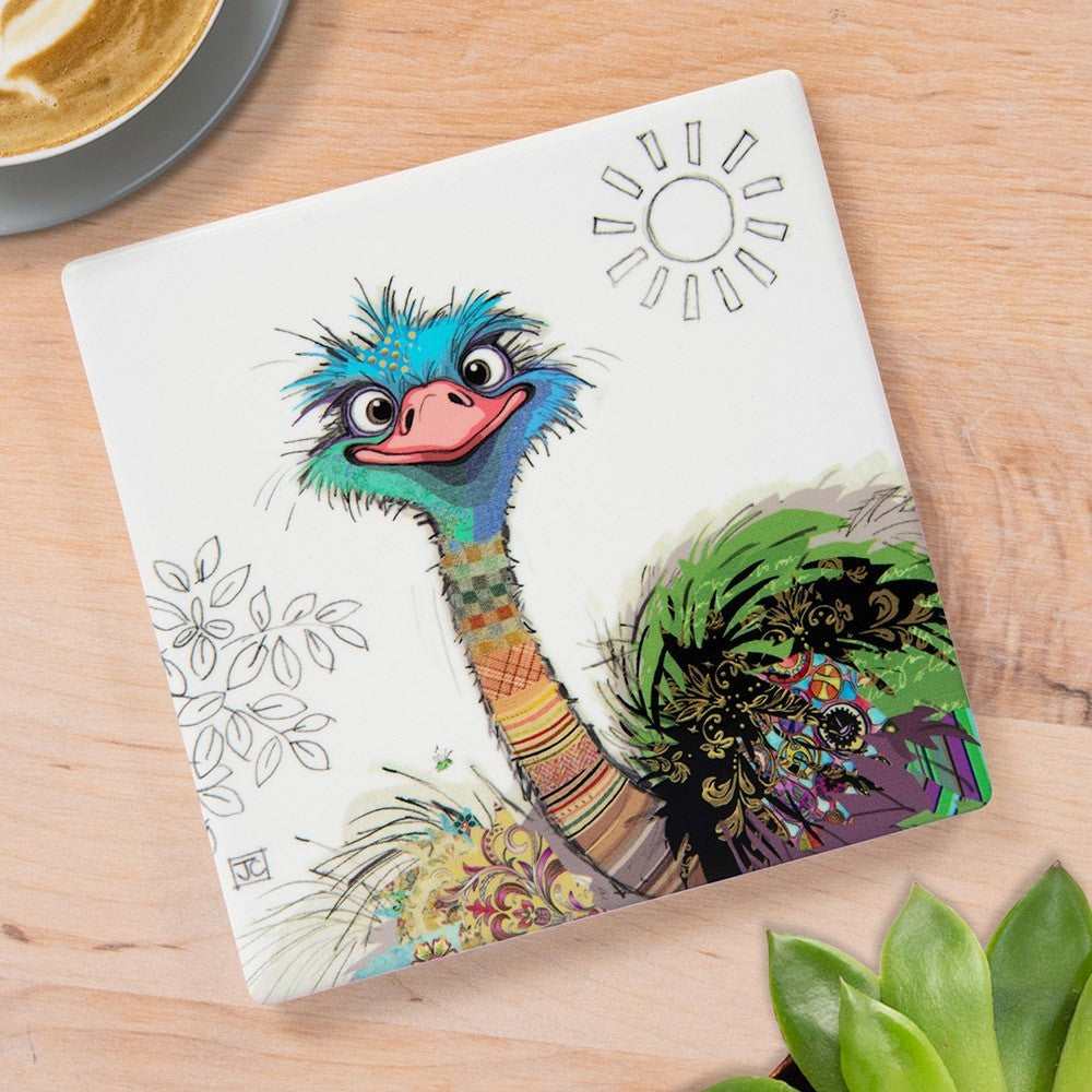 Cartco Bug Art Oscar Ostrich square ceramic coaster with colourful bird illustration and cork backing on wood table.