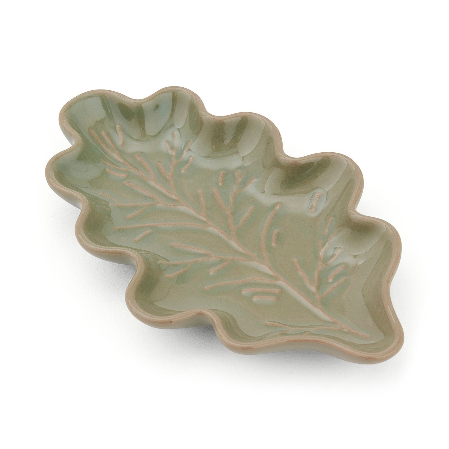 Cartco sage green ceramic spoon rest shaped like an oak leaf with embossed vein detailing for kitchen counters.