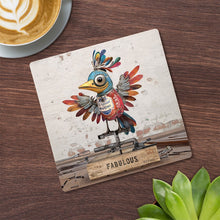 Cartco Bug Art Scrap Bird ceramic coaster with a patchwork bird illustration and cork backing on a wooden table.