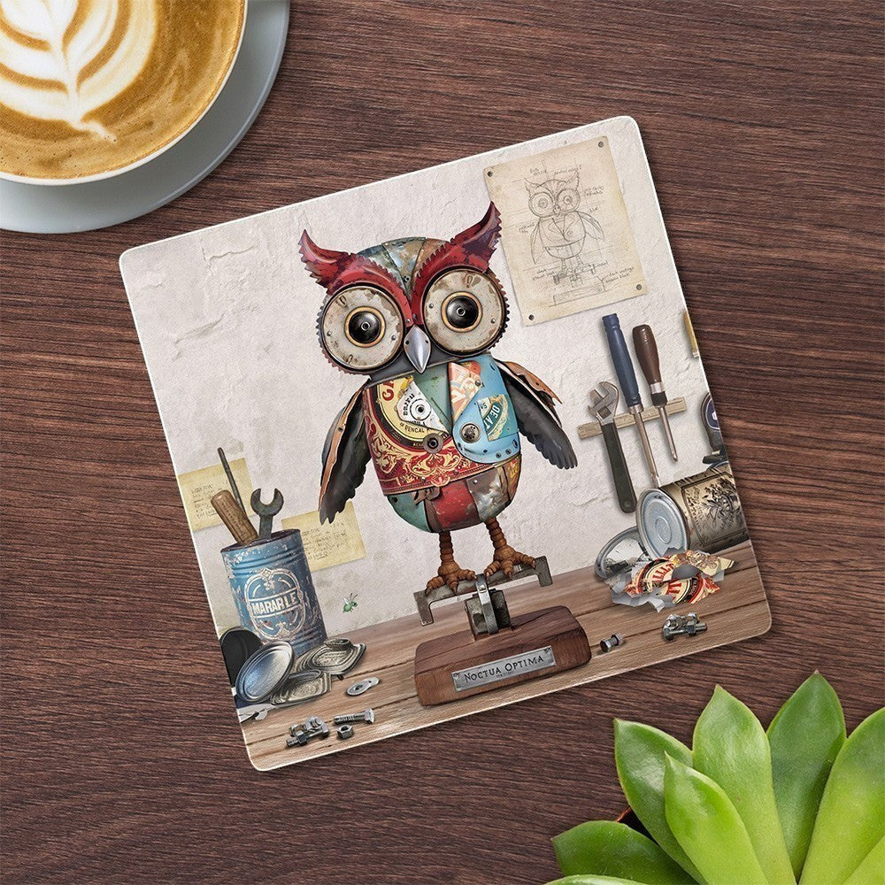 Cartco Bug Art Scrap Owl ceramic coaster featuring a mechanical owl illustration with cork backing on a wooden table.